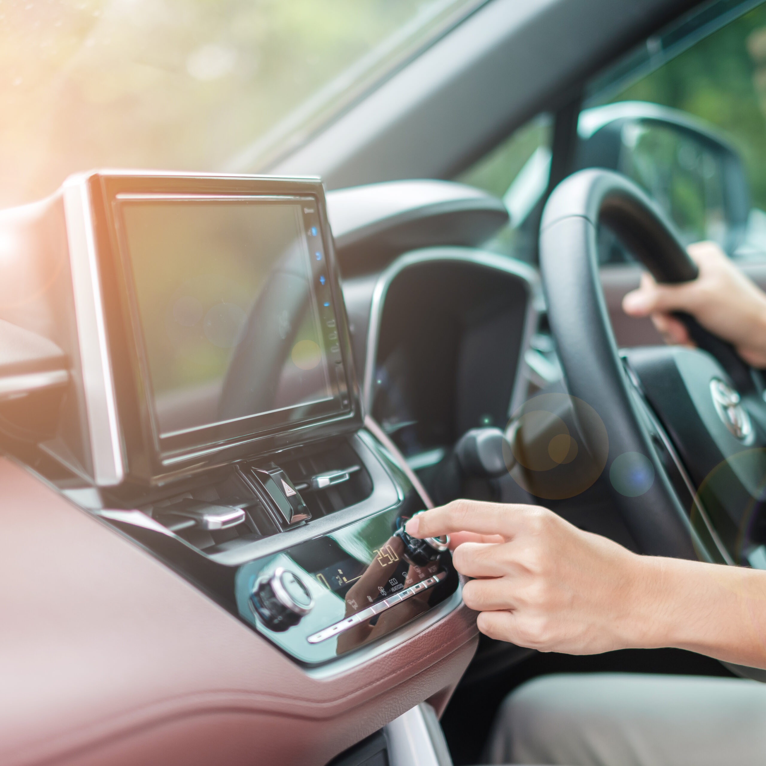 Woman hand adjusting temperature the air flowing during driving